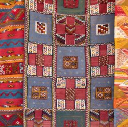 three assorted-color quilts