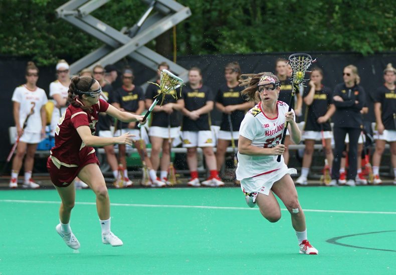 women playing lacrosse game during daytime
