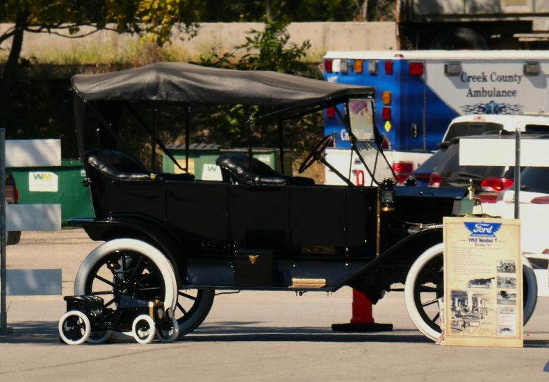 An old fashioned car parked in a parking lot